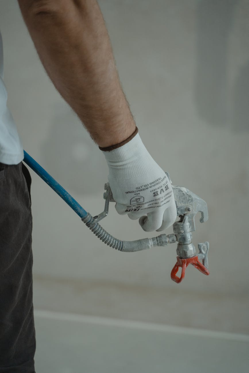 plumber holding silver faucet